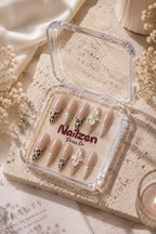 Leopard Bloom French press-on nails - nude leopard print tips with white 3D flower and gold ring accents
